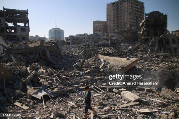 Palestinian citizens inspect damage to their homes caused by Israeli airstrikes on October 13, 2023 in Gaza City, Gaza. Israel has sealed off Gaza...