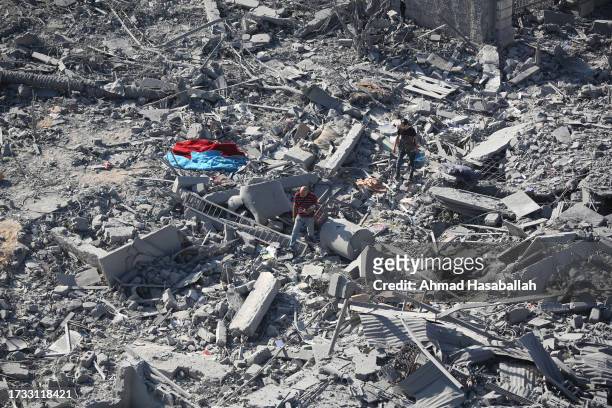 Palestinian citizens inspect damage to their homes caused by Israeli airstrikes on October 13, 2023 in Gaza City, Gaza. Israel has sealed off Gaza...