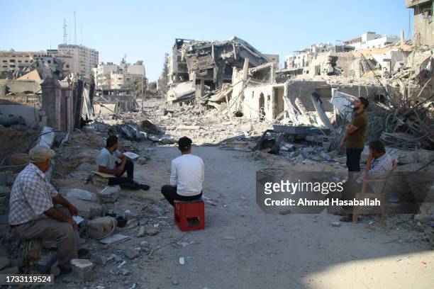 Palestinian citizens inspect damage to their homes caused by Israeli airstrikes on October 13, 2023 in Gaza City, Gaza. Israel has sealed off Gaza...