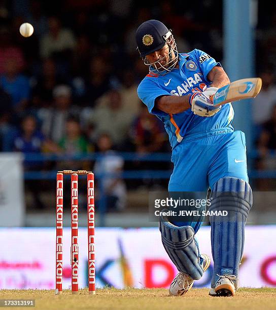 Indian cricket team captain Mahendra Sing Dhoni hits a boundary for six runs to seal their victory during the final match of the Tri-Nation series...