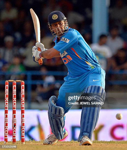 Indian cricket team captain Mahendra Sing Dhoni hits a boundary for six runs to seal their victory during the final match of the Tri-Nation series...