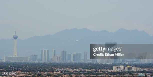 Drift smoke from the Carpenter 1 fire in the Spring Mountains range partially obscures the view of hotel-casinos on the Las Vegas Strip as seen from...