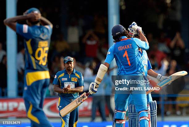 Indian cricket team captain Mahendra Sing Dhoni and his teammate Ishant Sharma celebrates their victory during the final match of the Tri-Nation...