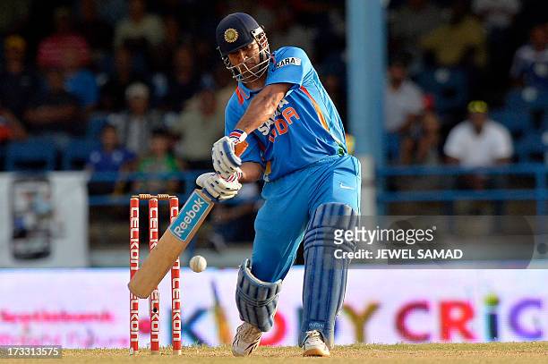 Indian cricket team captain Mahendra Sing Dhoni hits a boundary during the final match of the Tri-Nation series between India and Sri Lanka at the...