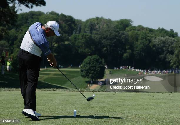 Fred Couples hits his tee shot on the tenth hole during the first round of the 2013 U.S. Senior Open Championship at Omaha Coutry Club on July 11,...