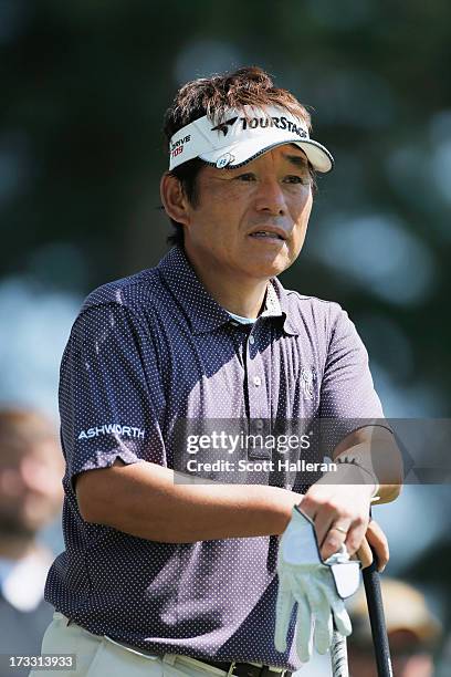 Joe Ozaki of Japan waits on a tee during the first round of the 2013 U.S. Senior Open Championship at Omaha Coutry Club on July 11, 2013 in Omaha,...