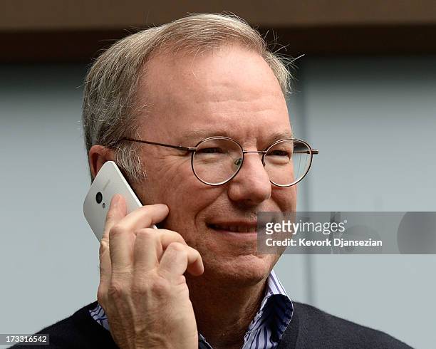 Eric Schmidt, executive chairman of Google, makes a call on still to be released Google produced Moto X phone during the Allen & Co. Annual...
