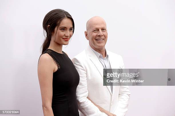 Actor Bruce Willis and Emma Heming attend the premiere of Summit Entertainment's "RED 2" at Westwood Village on July 11, 2013 in Los Angeles,...