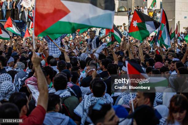 Protesters wave Palestinian flags during a demonstration in support of the Palestinians in Amman, Jordan, on Wednesday, Oct. 18, 2023. Thousands of...