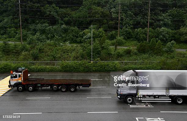 Trucks pass the Customs, Immigration and Quarantine office as they travel toward the Gaeseong Industrial Complex on a road, linked to North Korea,...