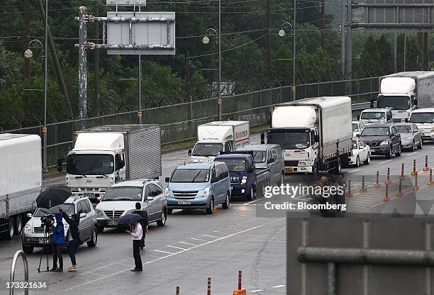 Members of the media film vehicles at the Customs, Immigration and Quarantine office as they travel toward the Gaeseong Industrial Complex, on a road...