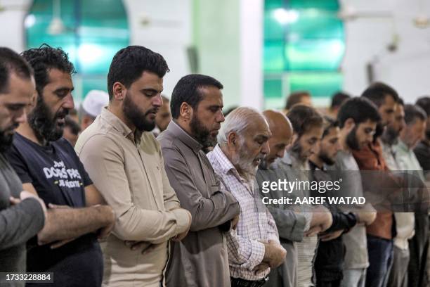 Muslim worshippers pray at al-Faruq mosque in the rebel-held town of al-Dana in Syria's northwestern Idlib province on October 18, 2023 in memorial...