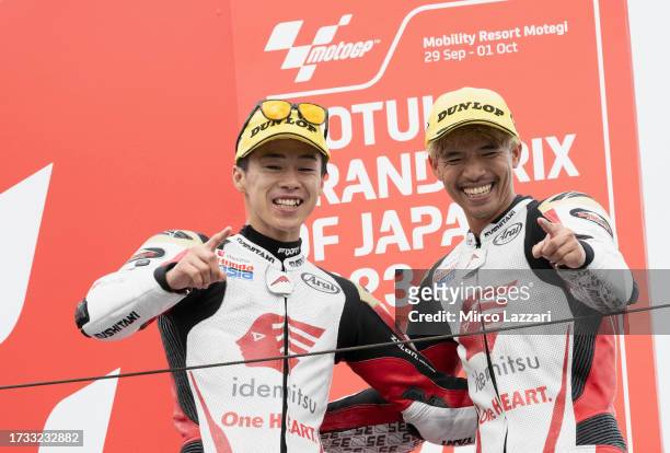 Ai Ogura of Japan and Idemitsu Honda Team Asia and Somkiat Chantra of Thailand and Idemitsu Honda Team Asia greet on the podium during the Moto2 race...