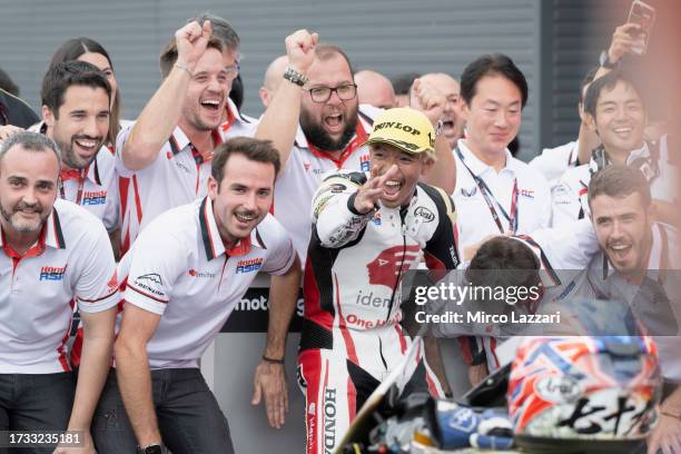 Somkiat Chantra of Thailand and Idemitsu Honda Team Asia celebrates the victory with team and jokes under the podium during the Moto2 race during the...