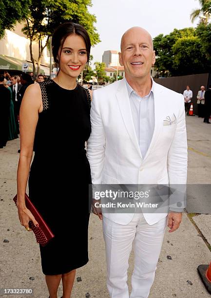 Actor Bruce Willis and Emma Heming attend the premiere of Summit Entertainment's "RED 2" at Westwood Village on July 11, 2013 in Los Angeles,...