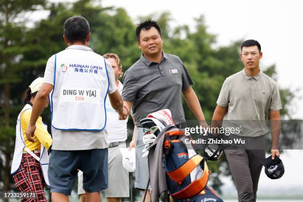 Jian Chuanlin of China shakes hand during Day One of the Hainan Open at Danzhou Ancient Saltern Golf Club on October 13, 2023 in Hainan Island, China.