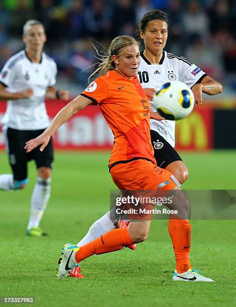 Dzsenifer Marozsan of Germany battles for the ball with Claudia van den Heiligenberg of Netherlands during the UEFA Women's Euro 2013 group B match...