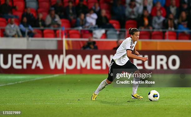 Lena Lotzen of Germany runs with the ball during the UEFA Women's Euro 2013 group B match at Vaxjo Arena on July 11, 2013 in Vaxjo, Sweden.