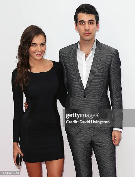 Musician Nick Simmons and guest attend the premiere of Summit Entertainment's "RED 2" at Westwood Village on July 11, 2013 in Los Angeles, California.