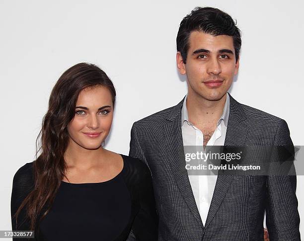 Musician Nick Simmons and guest attend the premiere of Summit Entertainment's "RED 2" at Westwood Village on July 11, 2013 in Los Angeles, California.