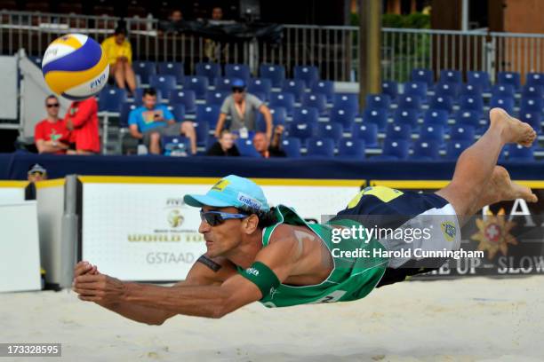 Brazil's Emanuel Rego dives during the Alison-Emanuel v Bockermann-Urbatzka game as part of the FIVB Gstaad Grand Slam third day on July 11, 2013 in...