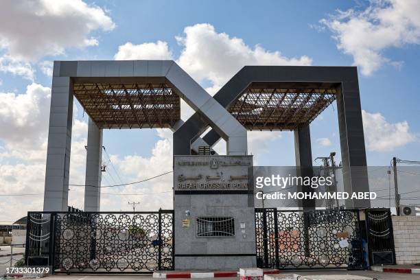 This picture taken on October 19, 2023 shows a view of the gate to the Rafah border crossing with Egypt in the southern Gaza Strip. Palestinians in...