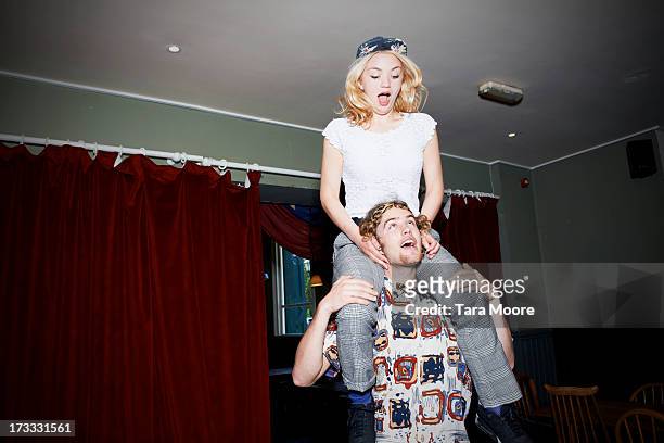 man with woman on shoulders having fun - carrying on shoulders stock pictures, royalty-free photos & images