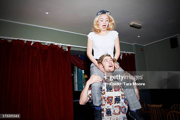 man with woman on shoulders having fun - shoulder rides stock pictures, royalty-free photos & images
