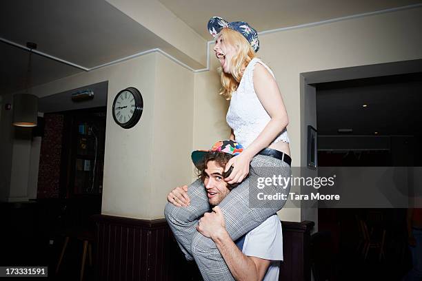 man with woman on shoulders having fun - on shoulders stock pictures, royalty-free photos & images