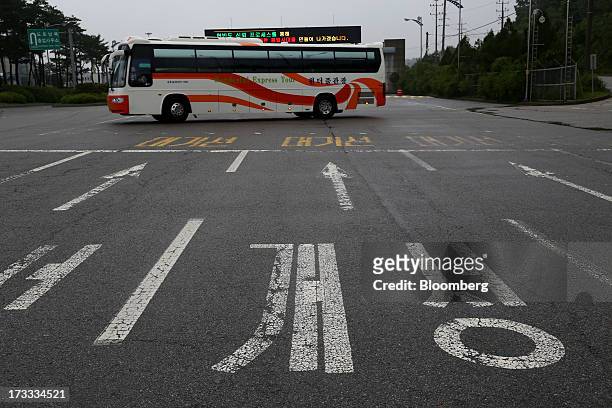Bus passes behind road surface markings for North Korean city Gaeseong in front of a gate at the Customs, Immigration and Quarantine office, near the...