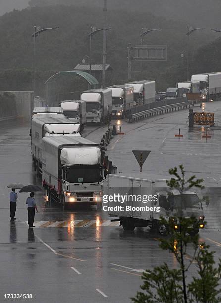 Vehicles returning from the Gaeseong Industrial Complex wait in line on a road linked to North Korea towards the Customs, Immigration and Quarantine...