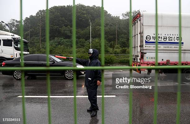 Guard directs vehicles returning from Gaeseong Industrial Complex at the Customs, Immigration and Quarantine office near the demilitarized zone in...