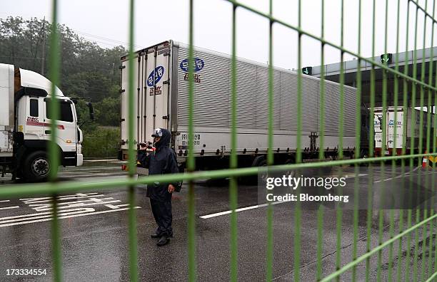 Guard directs vehicles returning from Gaeseong Industrial Complex at the Customs, Immigration and Quarantine office near the demilitarized zone in...