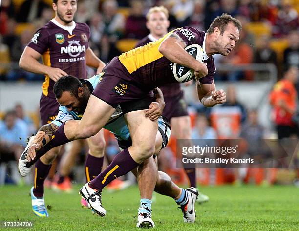 Scott Anderson of the Broncos attempts to break away from the defence during the round 18 NRL match between the Brisbane Broncos and the Cronulla...