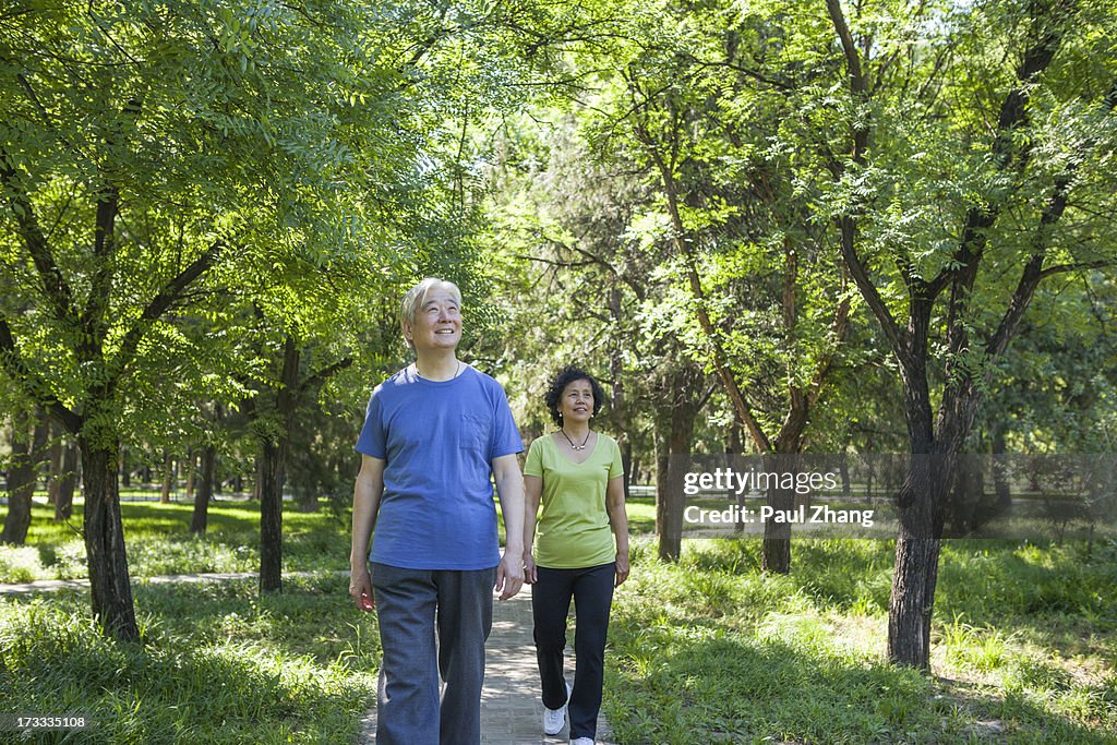 Asian couple doing exercise in park