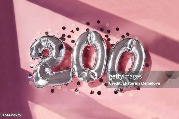 silver numbers 200 two hundred years balloons in sunlight pink background - 200 stock pictures, royalty-free photos & images