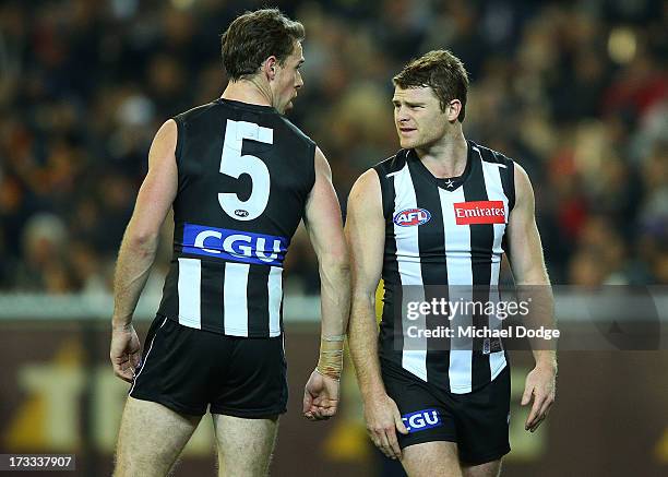 Heath Shaw of the Magpies argues with teamate Nick Maxwell after he had a goal kicked on him during the round 16 AFL match between the Collingwood...