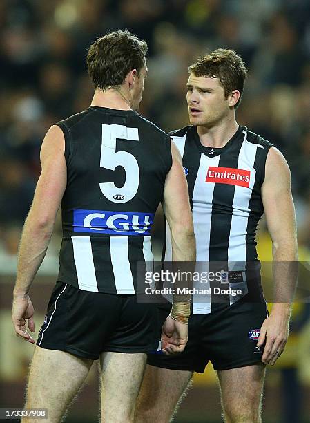Heath Shaw of the Magpies argues with teamate Nick Maxwell after he had a goal kicked on him during the round 16 AFL match between the Collingwood...