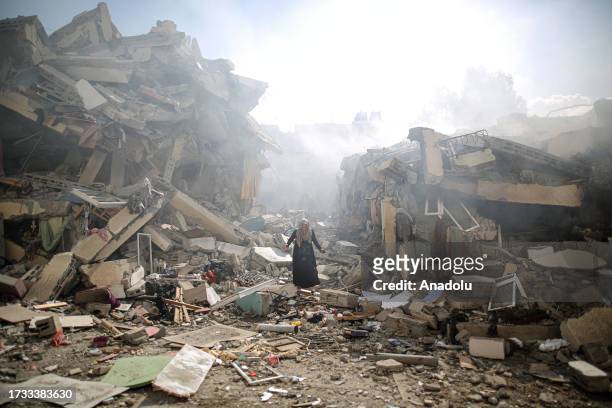 Resident gets upset as she walks amid near the rubble of residential buildings after Israeli airstrikes at al-Zahra neighborhood in Gaza Strip on...