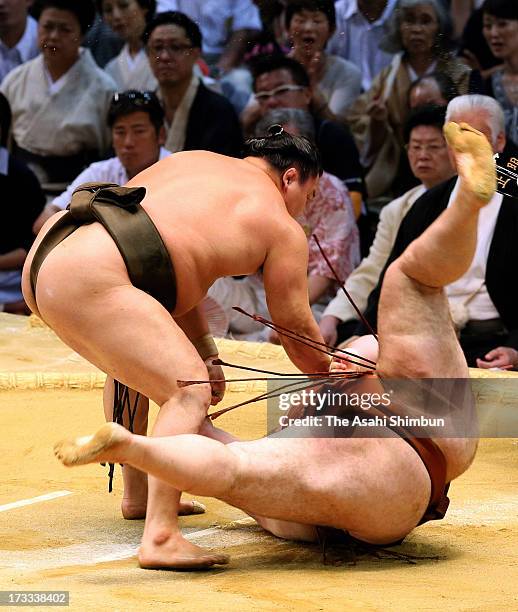 Mongolian Yokozuna, sumo's grand champion Hakuho, whose real name is Mnkhbatyn Davaajargal throws Georgian wrestler Gagamaru, whose real name is...