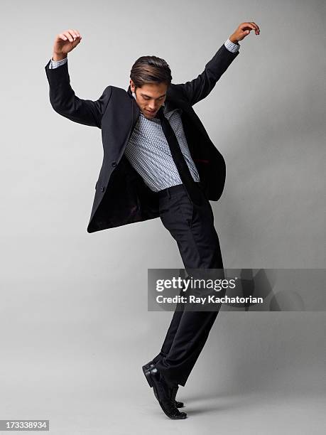 man standing on toes - man with arms raised stock pictures, royalty-free photos & images