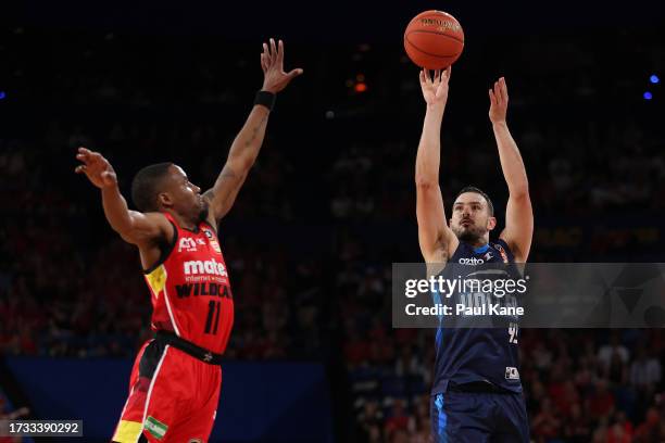 Chris Goulding of Melbourne United puts a shot up against Bryce Cotton of the Wildcats during the round three NBL match between Perth Wildcats and...