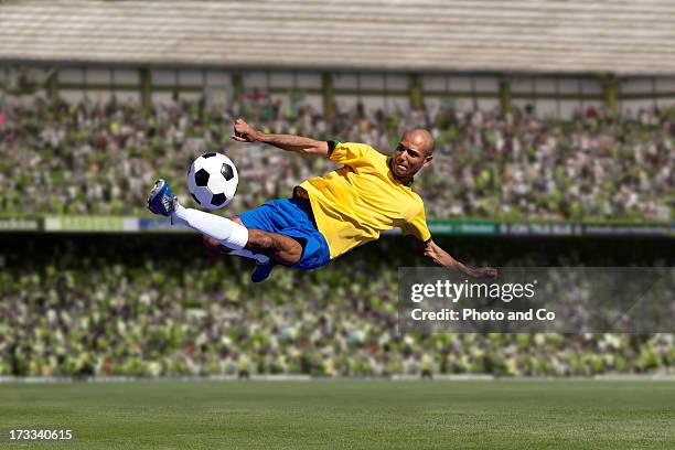 soccer player kicking - bicycle kick stock pictures, royalty-free photos & images