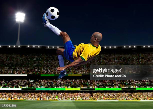 soccer player kicking in stadium - brazilian playing football fotografías e imágenes de stock