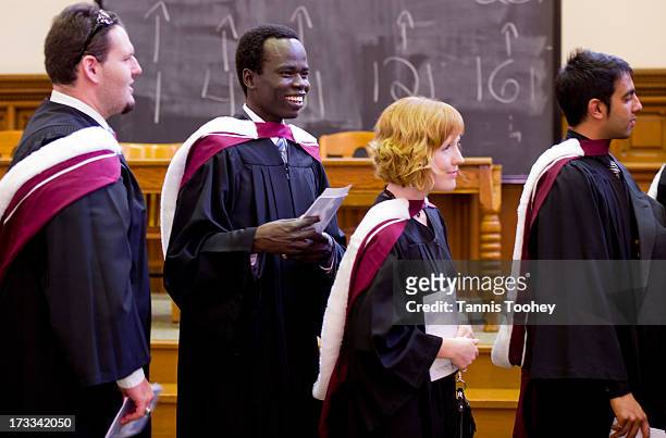Simon Kuany grins as graduates start the walk to Convocation Hall to graduate from mineral engineering at U of T. Kuany is one of the so-called...