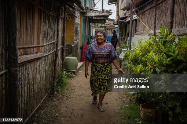 Magdalena walks down the street where she owns a small food and drink store on October 11, 2023 in Gardi Sugdub, Panama. Indigenous communities of...