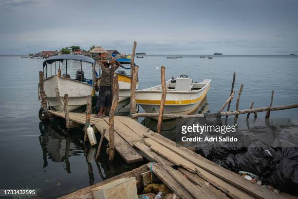 Fisherman watches his boat on one of the island's docks on October 11, 2023 in Gardi Sugdub, Panama. Indigenous communities of the small island,...