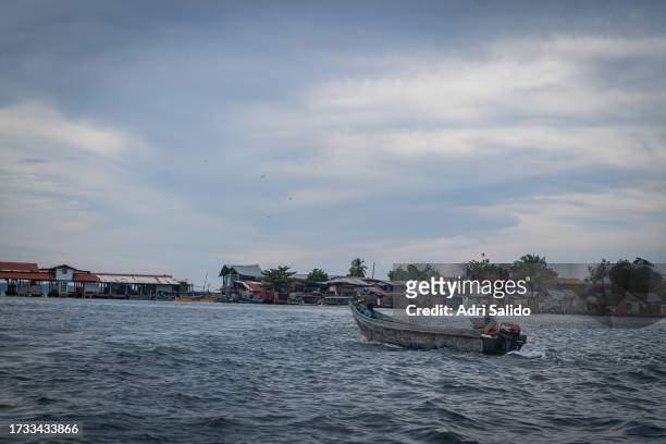 Man heads to the island with his boat on October 11, 2023 in Gardi Sugdub, Panama. Indigenous communities of the small island, located in an...
