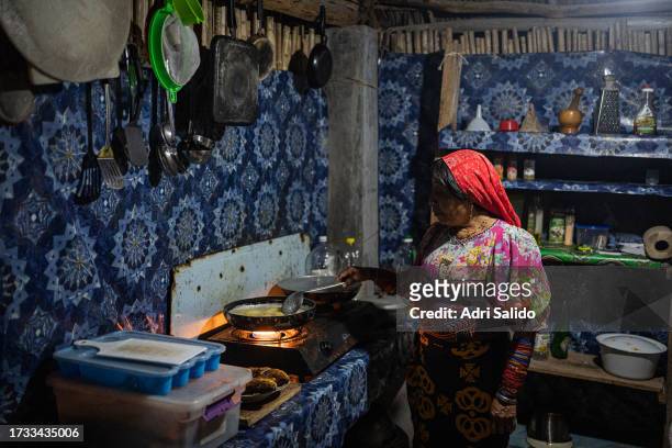 Woman wearing traditional Kuna clothes cooks dinner in her kitchen on October 11, 2023 in Gardi Sugdub, Panama. Indigenous communities of the small...
