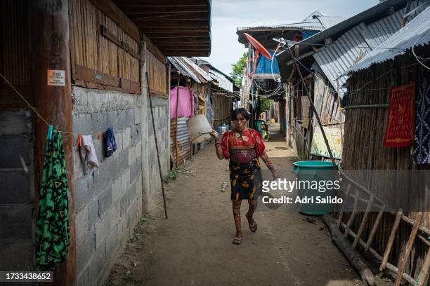 Woman wearing traditional Kuna clotes walks down one of the streets of the community on October 11, 2023 in Gardi Sugdub, Panama. Indigenous...